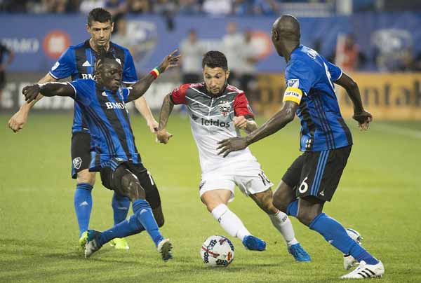 D.C. United's Luciano Acosta (10) breaks through challenges by Montreal Impact's Dominic Oduro (center) Blerim Dzemaili (left) and Hassoun Camara (6) during the second half of an MLS soccer match in Montreal on Saturday.