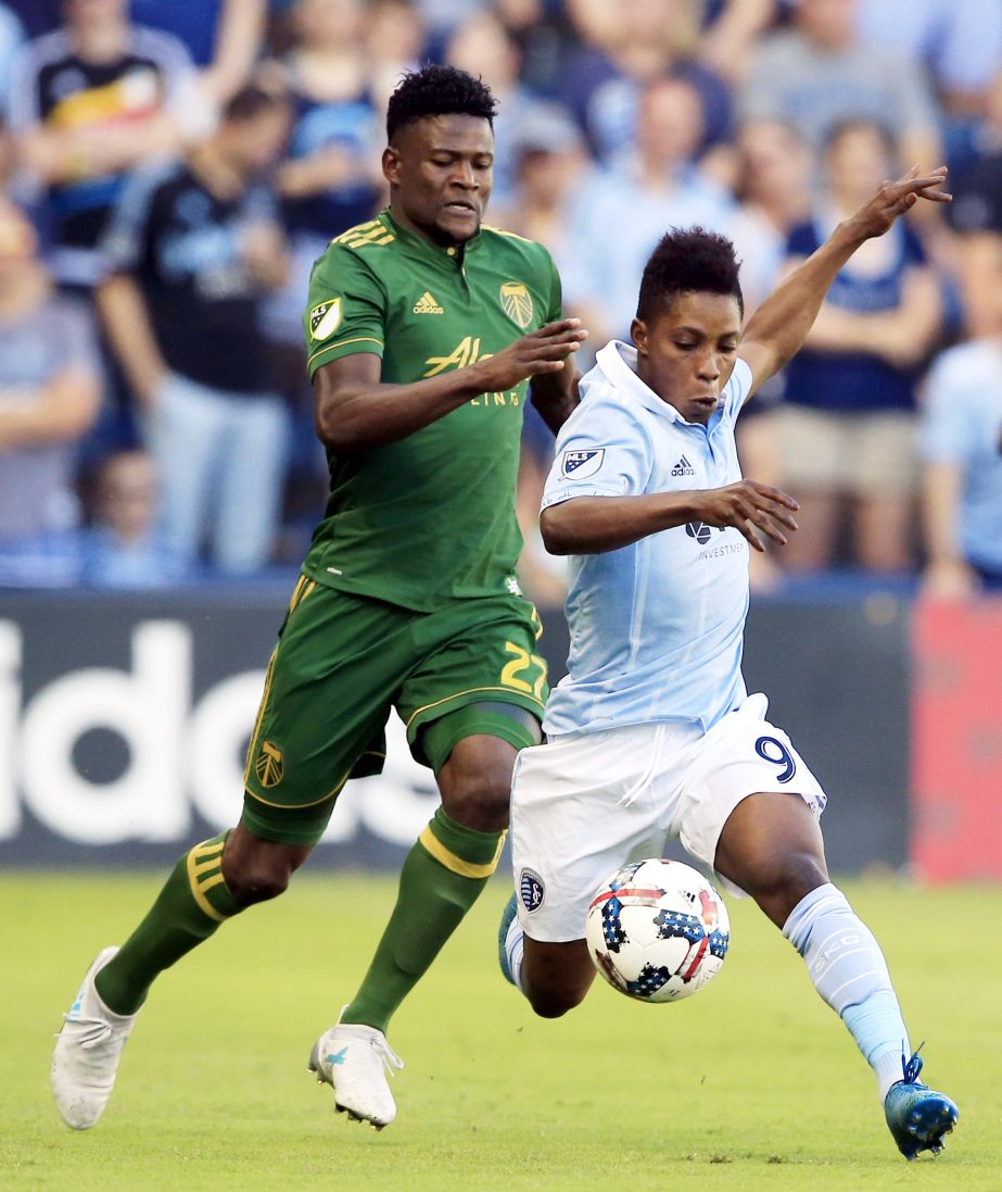 Sporting Kansas City forward Latif Blessing (9) and Portland Timbers forward Dairon Asprilla (27) race for the ball during the first half of an MLS soccer match in Kansas City, Kan. on Saturday,