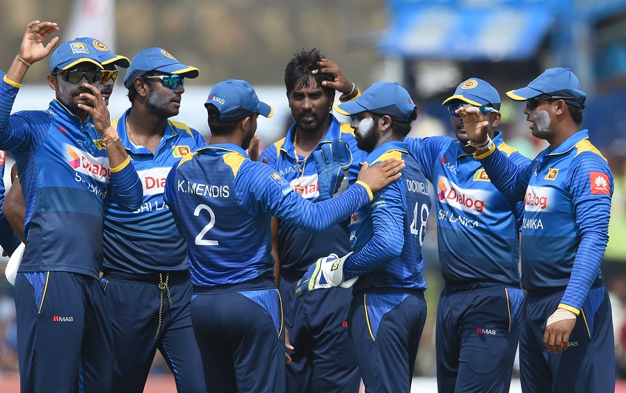 Sri Lanka's Nuwan Pradeep (C) celebrates with his teammates after he dismissed Zimbabwe's Solomon Mire during the second One-Day Internationals (ODI) cricket match between Sri Lanka and Zimbabwe at the Galle International Cricket Stadium in Galle on Sun
