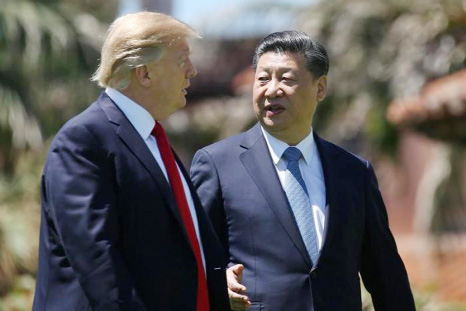 U.S. President Donald Trump and China's President Xi Jinping chat as they walk along the front patio of the Mar-a-Lago estate after a bilateral meeting in Palm Beach, Florida, U.S.