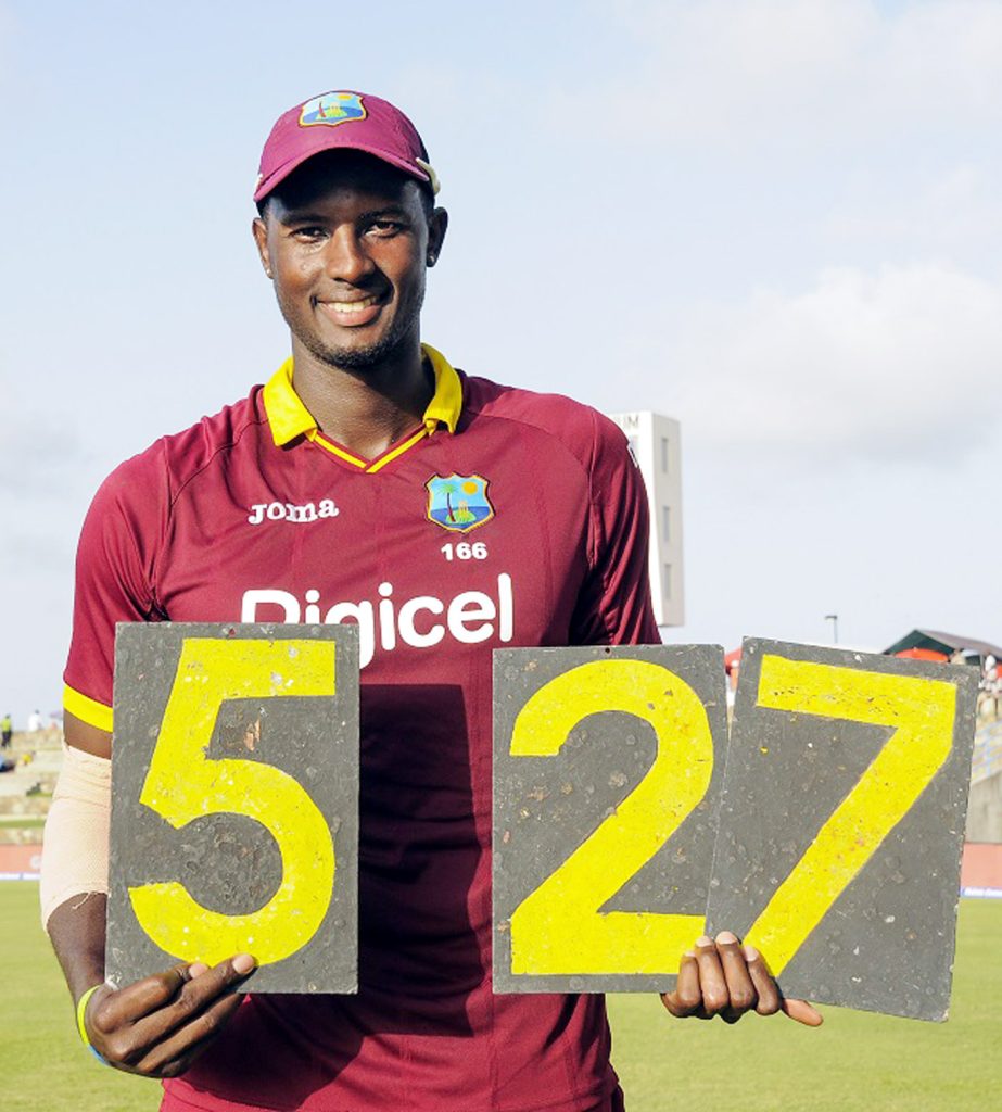 Jason Holder holds the scoring plates that shout out his best figuresduring the 4th ODI match between West Indies and India at Sir Vivian Richards Cricket Ground, North Sound, Antigua on Sunday.