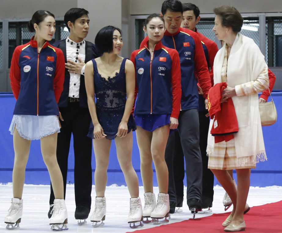 Britain's Princess Anne (right) talks with Sui Wenjing, third from left, Han Cong, second left, and other figure skaters at the Capital Stadium in Beijing on Wednesday.