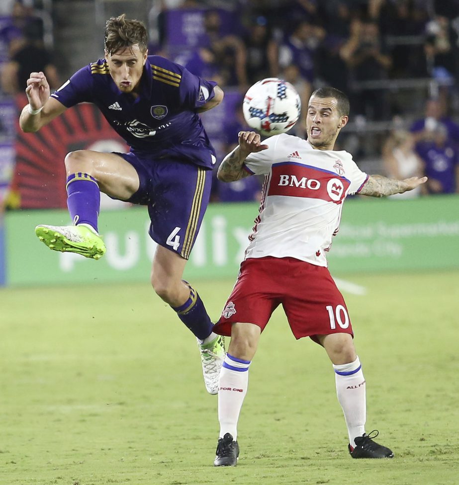 Orlando City's Jose Aja (4) and Toronto FC's Sebastian Giovinco (10) vie for the ball during an MLS soccer match in Orlando, Fla on Wednesday.