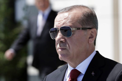 Turkey's President Recep Tayyip Erdogan walks before a welcome ceremony for Indonesian President Joko Widodo at the presidential palace in Ankara, Turkey on Thursday