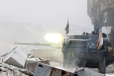 An armoured personnel carrier of Iraqi security forces fire against Islamic State militants at the frontline in the Old City of Mosul, Iraq.