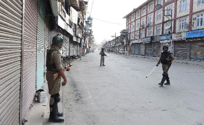 Paramilitary troops patrol the deserted streets of Srinagar as Indian Kashmir marks the first anniversary of a hugely popular rebel leader's death.