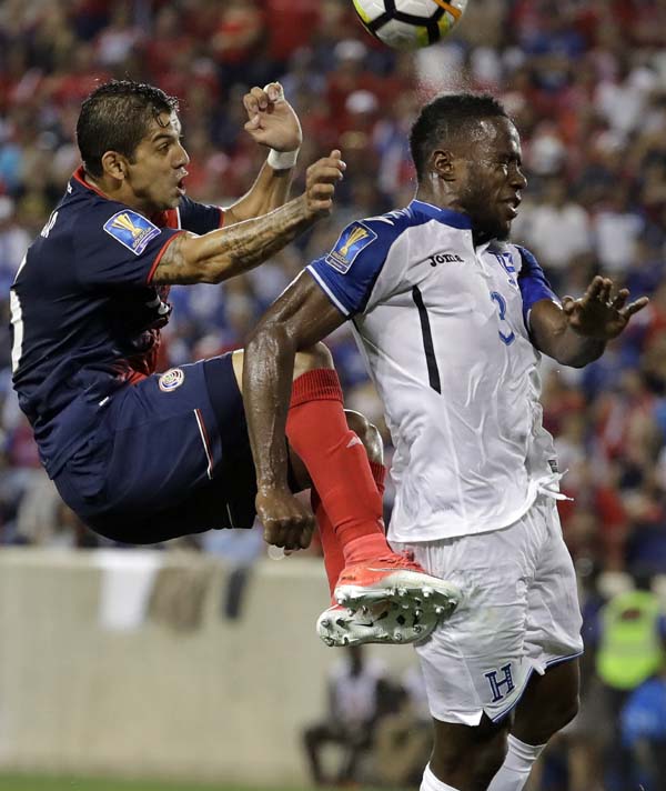 Costa Rica defender Christian Gamboa (left) and Honduras defender Maynor Figueroa collide during the first half of a CONCACAF Gold Cup soccer match in Harrison, N.J., Friday.