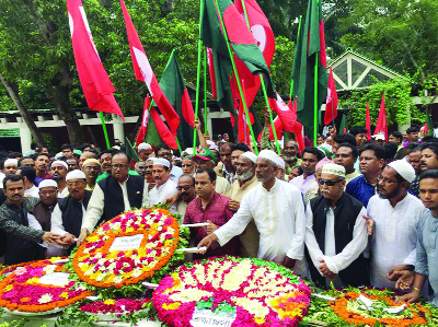GOPALGANJ: Minister for Water Resources Md Nazrul Islam Hiru MP with leaders of Awami League and its front organisations placing wreaths at the mazar of Bangabandhu Sheikh Mujibur Rahman at Tungipara on Friday.