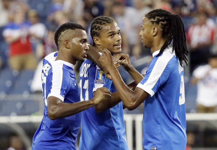 Martinique's Stephane Abaul (left) Christof Jougon (center) and Antony Angely celebrate the team's 2-0 win over Nicaragua in a CONCACAF Gold Cup soccer match in Nashville, Tenn on Saturday.