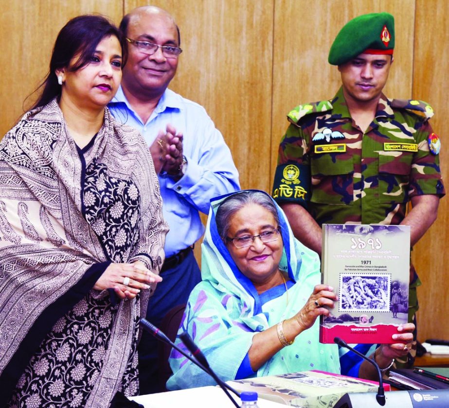 Prime Minister Sheikh Hasina unveiling the cover of album titled 'War Crimes in Bangladesh in 1971' at the cabinet room of Bangladesh Secretariat on Monday. PID photo