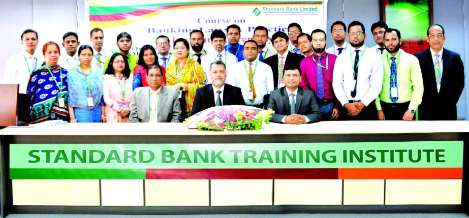 Mamun-Ur-Rashid, Managing Director of Standard Bank Limited, poses with the participants of a 3 day-long course on "Banking Laws & Practices" at its Training Institute recently. Md. Zakaria, Principal and Md. Amzad Hossain Fakir, Faculty of the the Inst