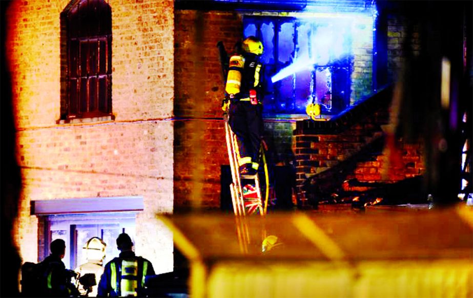 Firefighters tackle a fire at Camden Market in north London on Monday.