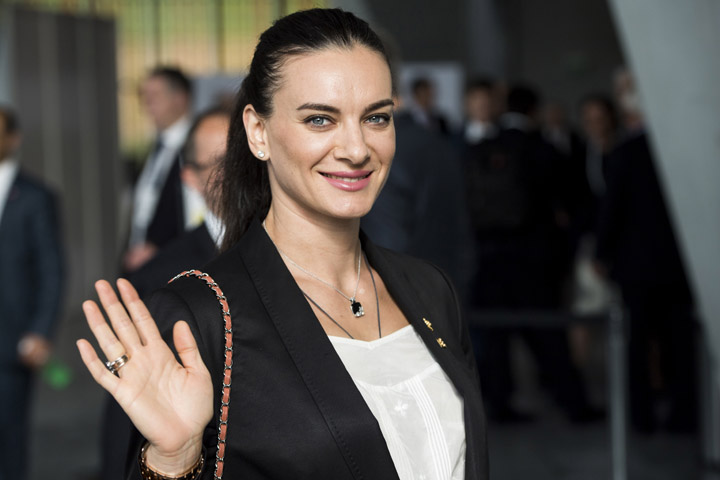 Former Russian pole vaulter Yelena Isinbayeva waves as she arrives for the presentation of Los Angeles 2024 Candidate City Briefing for International Olympic Committee (IOC) Members, at the SwissTech Convention Centre in Lausanne, Switzerland on Tuesday.