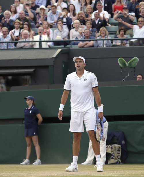 Luxembourg\'s Gilles Muller pauses after beating Spain\'s Rafael Nadal in their Men\'s Singles Match on day seven at the Wimbledon Tennis Championships in London on Monday.