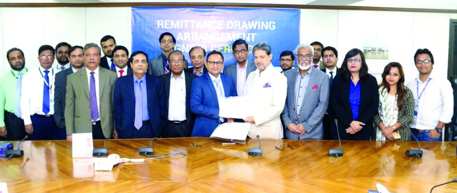 Choudhury Moshtaq Ahmed, Managing Director (CC) of National Bank Limited and Abdus Salam, Managing Director of BRAC Saajan Exchange Ltd, sign a deal at the bank's head office on Tuesday. Under this deal, Bangladeshis residing in England and in other Euro
