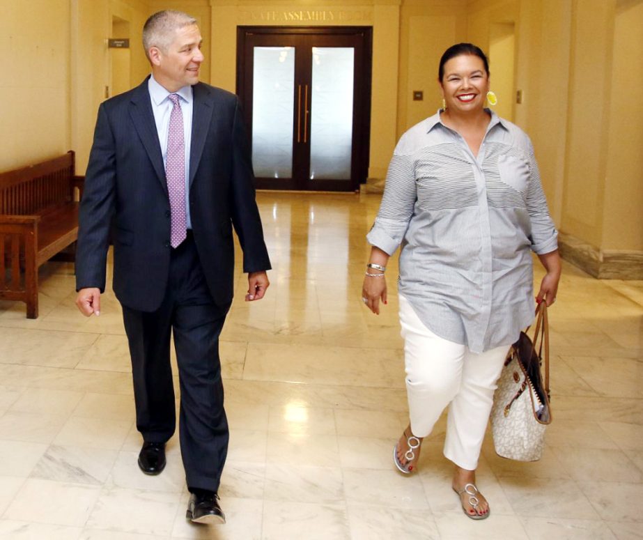 Newly elected Oklahoma state Sen. Michael Brooks walks with his wife, Jessica Martinez-Brooks, right, during a tour of the state Capitol in Oklahoma City on Wednesday