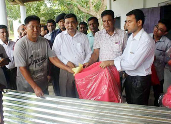 Md Manzarul Mannan, DC, Rangamati distributing relief under the Government Rehabilitation Programme for Langadu arson victims on Wednesday.