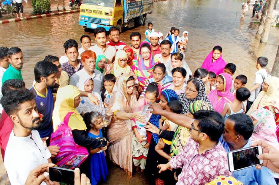 Hasina Mohiuddin, President, Chittagong City Mahila Awami League distributing relief goods among the flood-hit people in the outskirt of the Port City recently.
