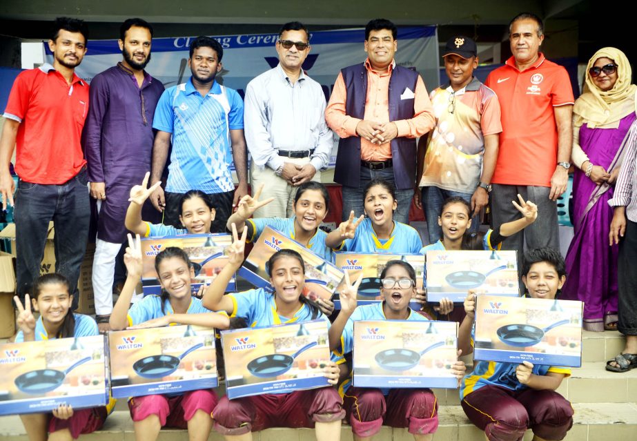 Members of Tongi Amzad Ali School & College, the champions of the Walton 1st Inter-College Women's Baseball Tournament with the guests and officials of Bangladesh Baseball-Softball Association pose for a photo session at Sultana Kamal Women's Sports Com