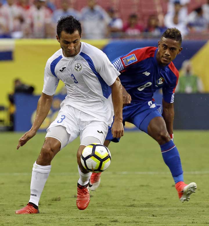 Nicaragua's Manuel Rosas (3) moves the ball past Panama's Edgar Barcenas during a CONCACAF Gold Cup soccer match in Tampa, Fla on Wednesday.