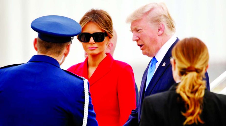 US President Donald Trump and first lady Melania Trump arrive aboard Air Force One at Orly airport near Paris.