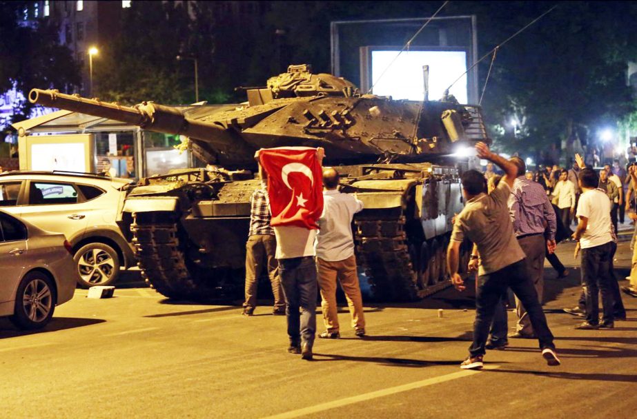 Tanks, part of the forces that attempted a coup, move into position as people attempt to stop them, in Ankara, Turkey.