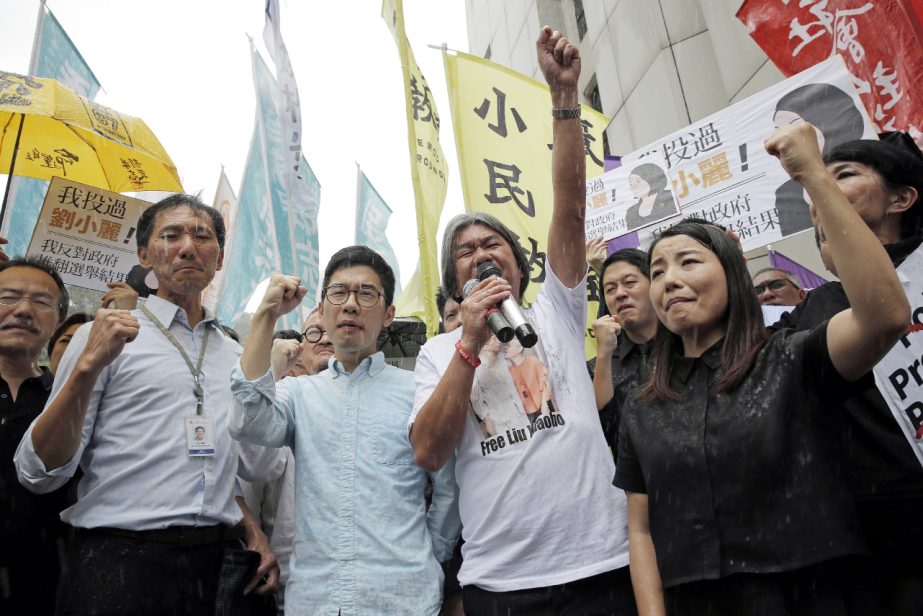 Nathan Law (L) and Leung Kwok-hung, also known as 'Long Hair', Â® were among four Hong Kong lawmakers disqualified for changing their oaths to reflect their frustrations with Chinese authorities.