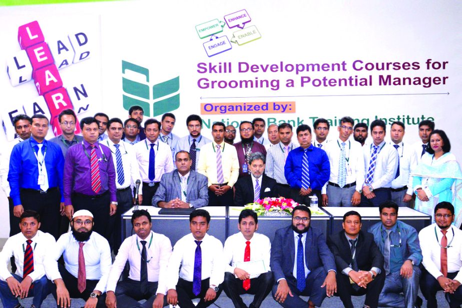 Choudhury Moshtaq Ahmed, Managing Director (CC) of National Bank Limited, poses with the participants of a short course on "Skill Development Course for Grooming a Potential Manager" at its training institute recently. ASM Bulbul and Shah Syed Abdul Bar