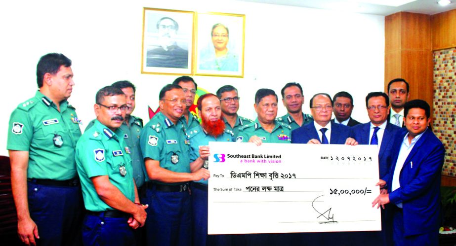 M. Kamal Hossain, Managing Director of Southeast Bank Limited, handing over a cheque of Tk 1.5m to Md.Asaduzzaman Mia, Dhaka Metropolitan Police Commissioner for "DMP Shikkhabritti 2017" fund at the latter's office on Wednesday.