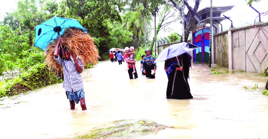 A vast areas of some villages in Cox's Bazar district go under water due to flood. People moving here and there for shelter. The snap was taken from Ramu on Thursday.
