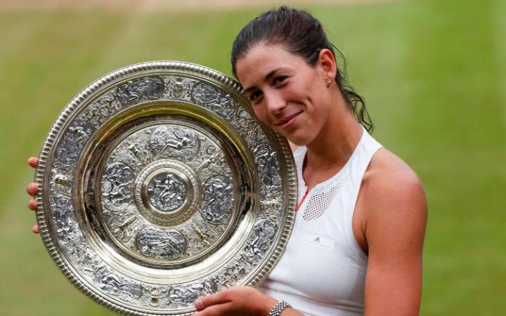 Garbine Muguruza poses with the Venus Rosewater dish after winning Wimbledon title on Saturday.