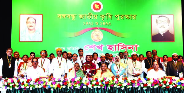 Prime Minister Sheikh Hasina poses for photograph along with the winners of 'Bangabandhu Jatiya Krishi Purashkar 1421 and 1422' at the award distribution ceremony in Osmani Memorial Auditorium in the city on Sunday. BSS photo