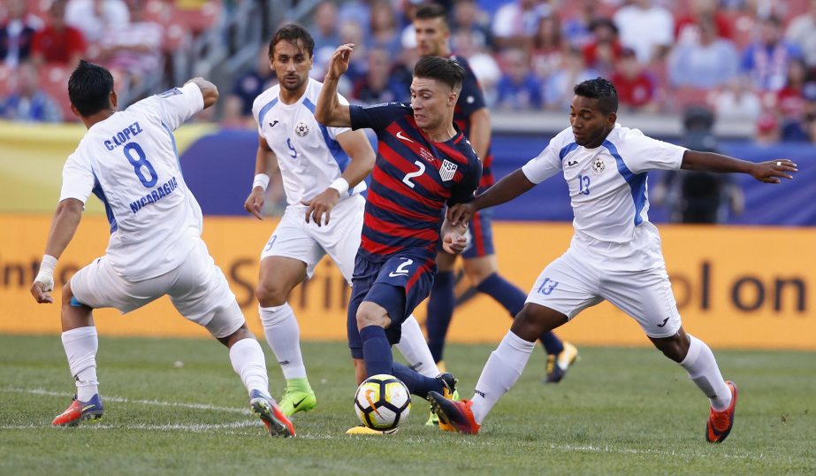 United States' Jorge Villafana (2) works through Nicaragua's Marlon Lopez (8), Daniel Candena (9) and Bryan Garcia (13) during a CONCACAF Gold Cup soccer match in Cleveland, Ohio on Saturday.