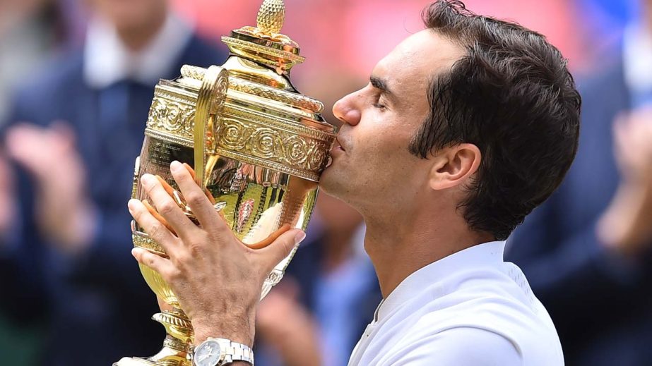 Switzerland's Roger Federer kisses the winner's trophy after beating Croatia's Marin Cilic in their men's singles final match during the presentation on the last day of the 2017 Wimbledon Championships at the All England Lawn Tennis Club in Wimbledon,