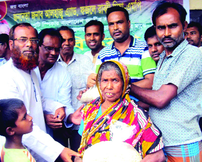 SAGHATA(Gaibandha): Leaders of Awami League and Jubo League distributing relief among the flood -hit people at Jumarbari Union donated by Deputy Speaker Fazle Rabbi Miah, MP recently.