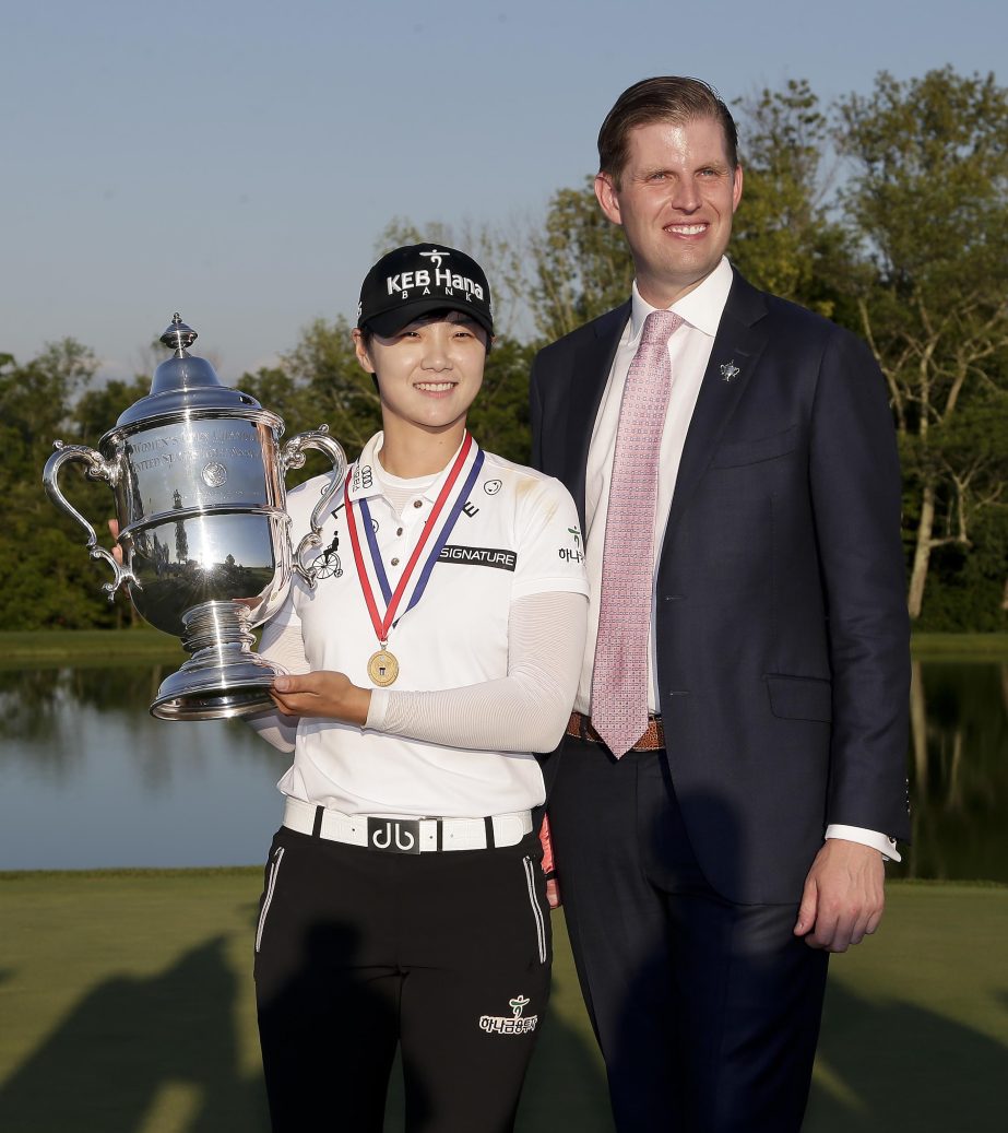 South Korea's Sung Hyun Park poses for a photo with Eric Trump as she holds up the championship trophy after winning the U.S. Women's Open Golf tournament in Bedminster, N.J. on Sunday.