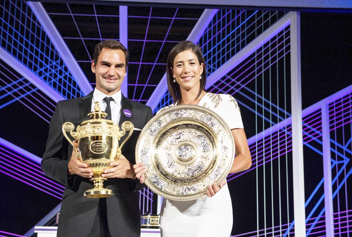 The 2017 Wimbledon singles champions Roger Federer of Switzerland and Garbine Muguruza of Spain pose with their trophies at the Champions Dinner at the Guildhall in London on early Monday.