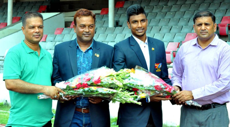 Officials of Bangladesh Athletics Federation receiving Mohammad Zahir Rayhan (2nd from right) with bouquet at the Bangabandhu National Stadium on Tuesday. Zahir of BKSP moved into the semifinal of 400 metre sprint in the World Youth Athletics Championship