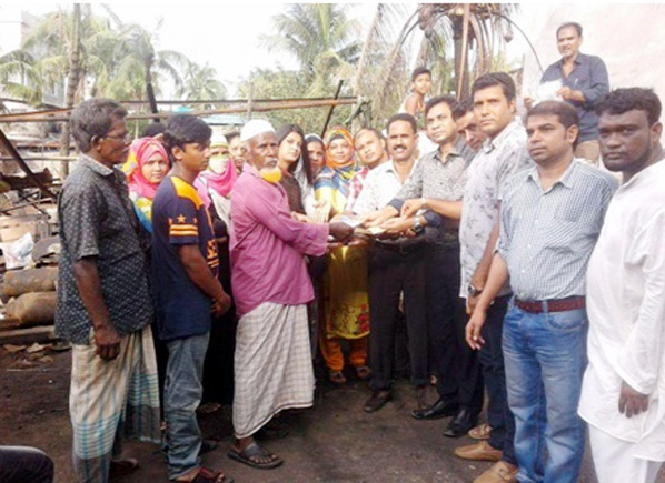 Leaders of Awami League distributing relief goods among the fire victim businessman in the port city donated by M A Latif MP recently.