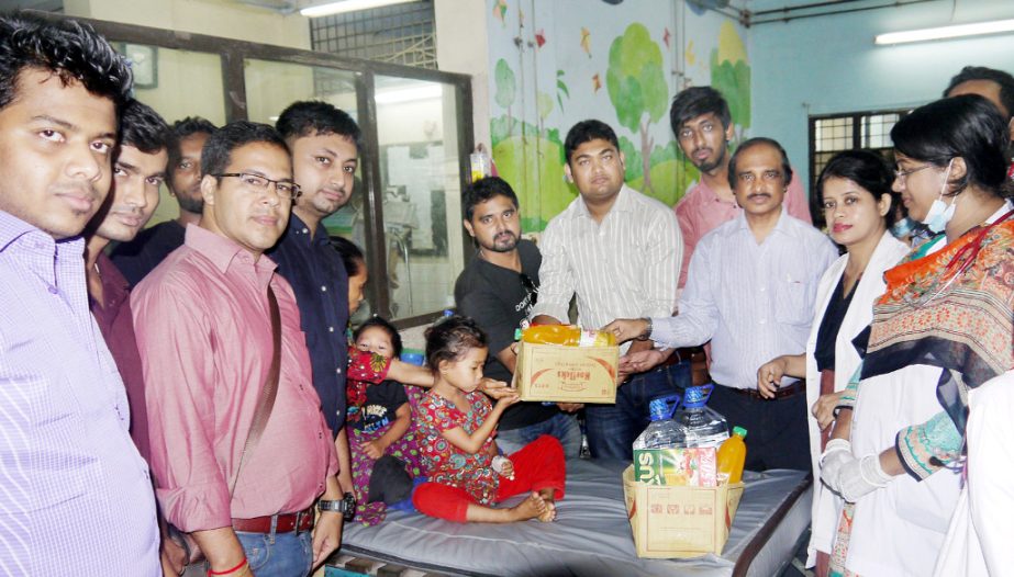 Dr Pronab Kumar Chowdhury, Chief of Child Health, Chittagong Medical College Hospital distributing nutritious food among the sick children of Sitakundo Tripura Village recently.