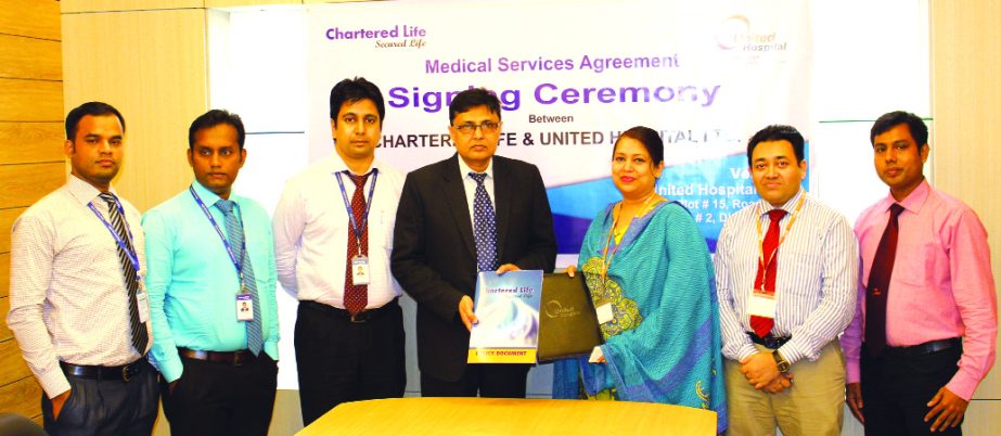 Md Shahidul Islam, Chief Executive Officer (CC) of Chartered Life Insurance Company Limited and Dr. Shagufa Anwar, Chief of Communication and Business Development of United Hospital Limited, exchanging the signing document at the hospital in the city rece