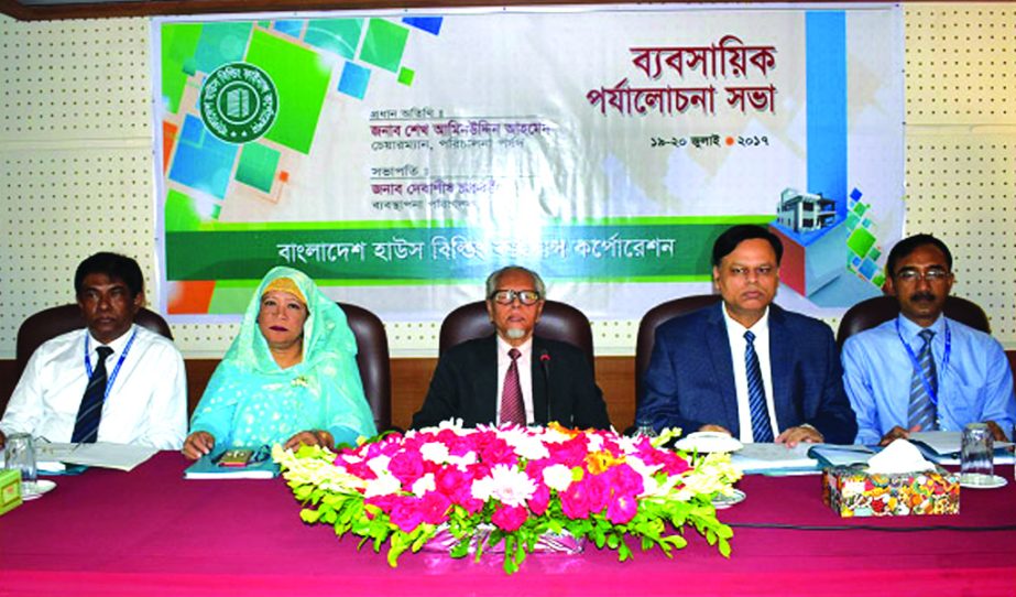 Debasish Chakrabarty, Managing Director of Bangladesh House Building Finance Corporation, presiding over the 'Business Review Conference-2017' at its Training Institute on Wednesday. Shaikh Aminuddin Ahmed, Chairman of the Board of Directors of the corp