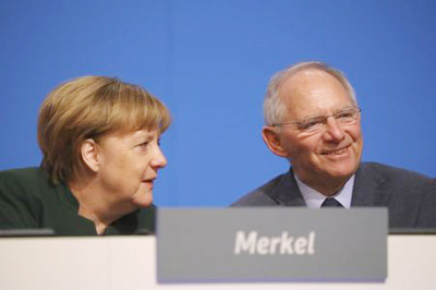 German Chancellor and leader of the conservative Christian Democratic Union party CDU Angela Merkel and German Finance Minister Wolfgang Schaeuble Â® attend the CDU party convention in Essen, Germany