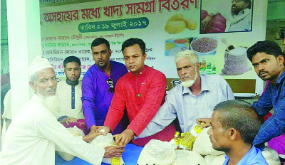 SYLHET: Rotarian Miraj Mostafa, President, Anawara Welfare Trust , UK distributing relief goods among the flood- hit people in Sylhet recently.