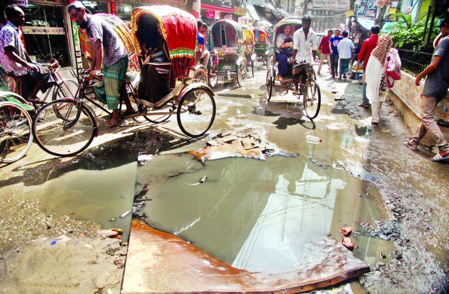 A big potholes and cracks being developed at Shantibagh in the city causing sufferings to commuters and local dwellers for long. This photo was taken on Saturday.