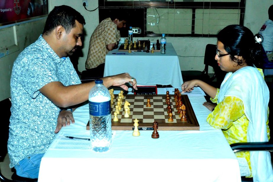 Grand Master Ziaur Rahman Zia (left) moves a pawn against his opponent during the match of the Saif Powertec International Rating Tournament at Bangladesh Chess Federation hall-room on Sunday.