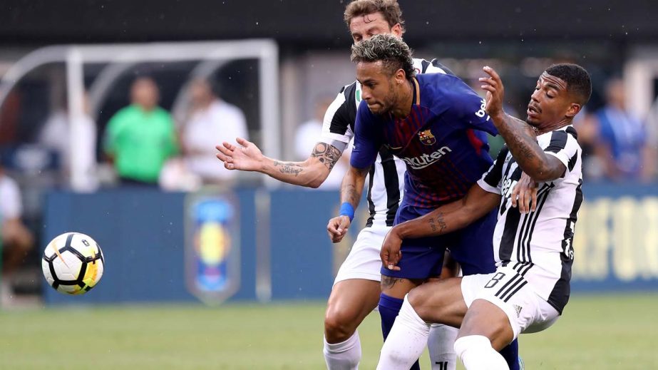 Mario Lemina #18 and Stefano Sturaro #27 of Juventus stop Neymar #11 of Barcelona as he tries to score in the first half during the International Champions Cup 2017 at MetLife Stadium in East Rutherford, New Jersey on Saturday.