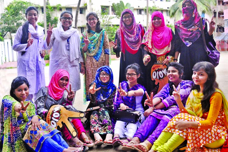 Students of the city's Motijheel Ideal School and College showing victory (V) sign on its campus on Sunday for their brilliant results in the HSC examination.