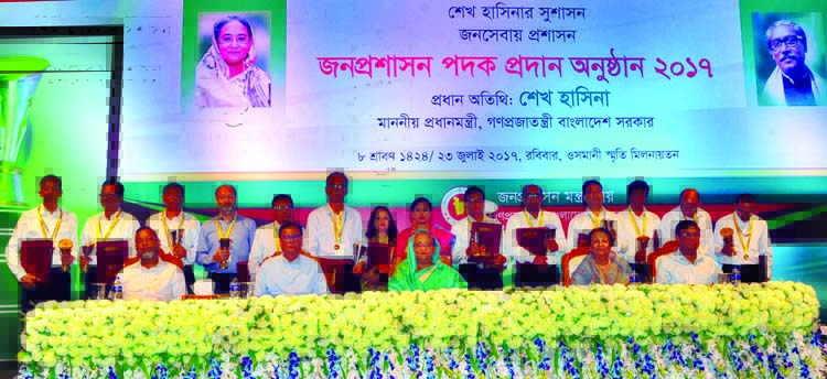 Prime Minister Sheikh Hasina poses for photograph with the recipients of Public Administration Medal at Osmani Memorial Auditorium in the city on Sunday. Photo: BSS