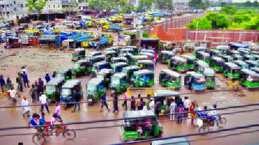 Auto-rickshaws, trucks, covered vans and lorries parked illegally around the Rayerbazar graveyard in the city narrowing the road under the patronage of vested quarters. This photo was taken on Friday.